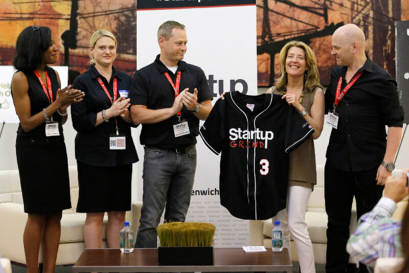 LM-T2-Body-images-1000×667-Bottom_Right Startup Grind event with staff congratulating a woman